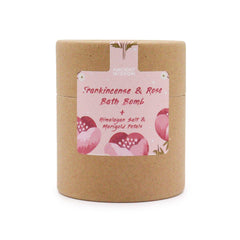 Frankincense and rose bath bomb by AW GIFTS with rose petals and herbal ingredients in a clear glass bowl.