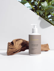 Selfnamed moisturizing conditioner bottle with pump for nourishing hair care and hydration.