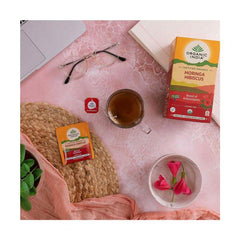 Organic India BIO Moringa and Hibiscus tea infusion bags, natural herbal tea with vibrant hibiscus flowers and green moringa leaves.