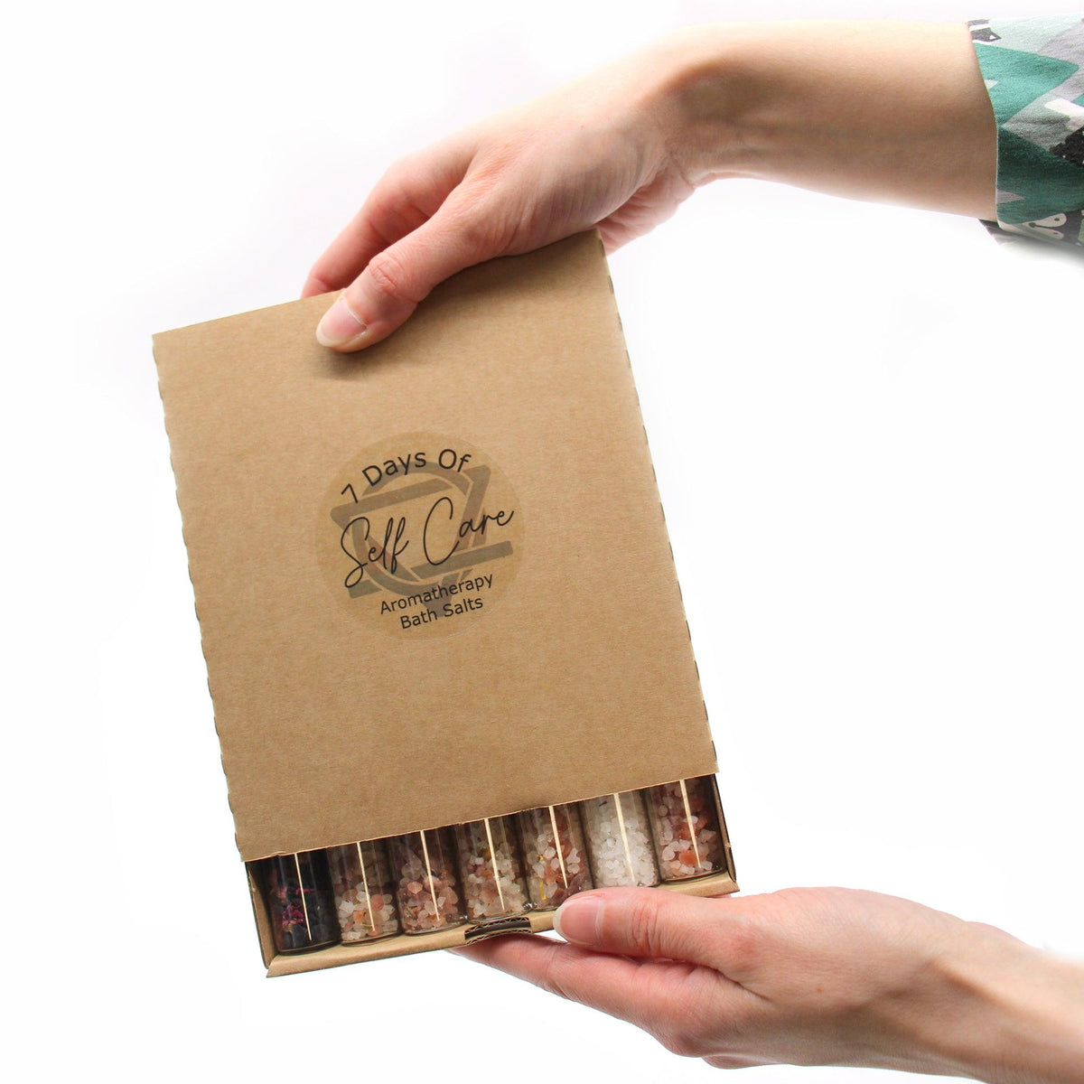 Set of seven AW GIFTS bath salts in small glass vials, ideal for gift packs and relaxing bath experiences.