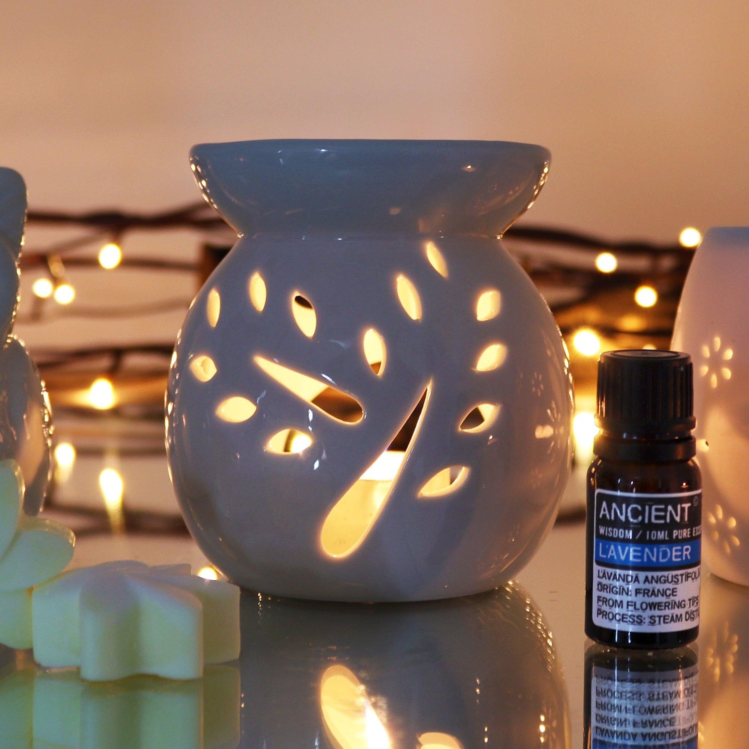 Large white oil burner by AW Gifts featuring a tree cut-out design, used as an essential accessory for aromatherapy.