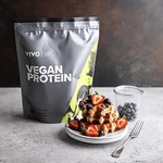 Vivo Life plant-based protein powder with 30 servings, showing the powder in a scoop and packaging in the background.