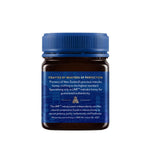 Herbalistas Haddrells Manuka Honey UMF5+ MGO83+ in 250g jar, showcasing the golden, thick honey with a honey dipper.