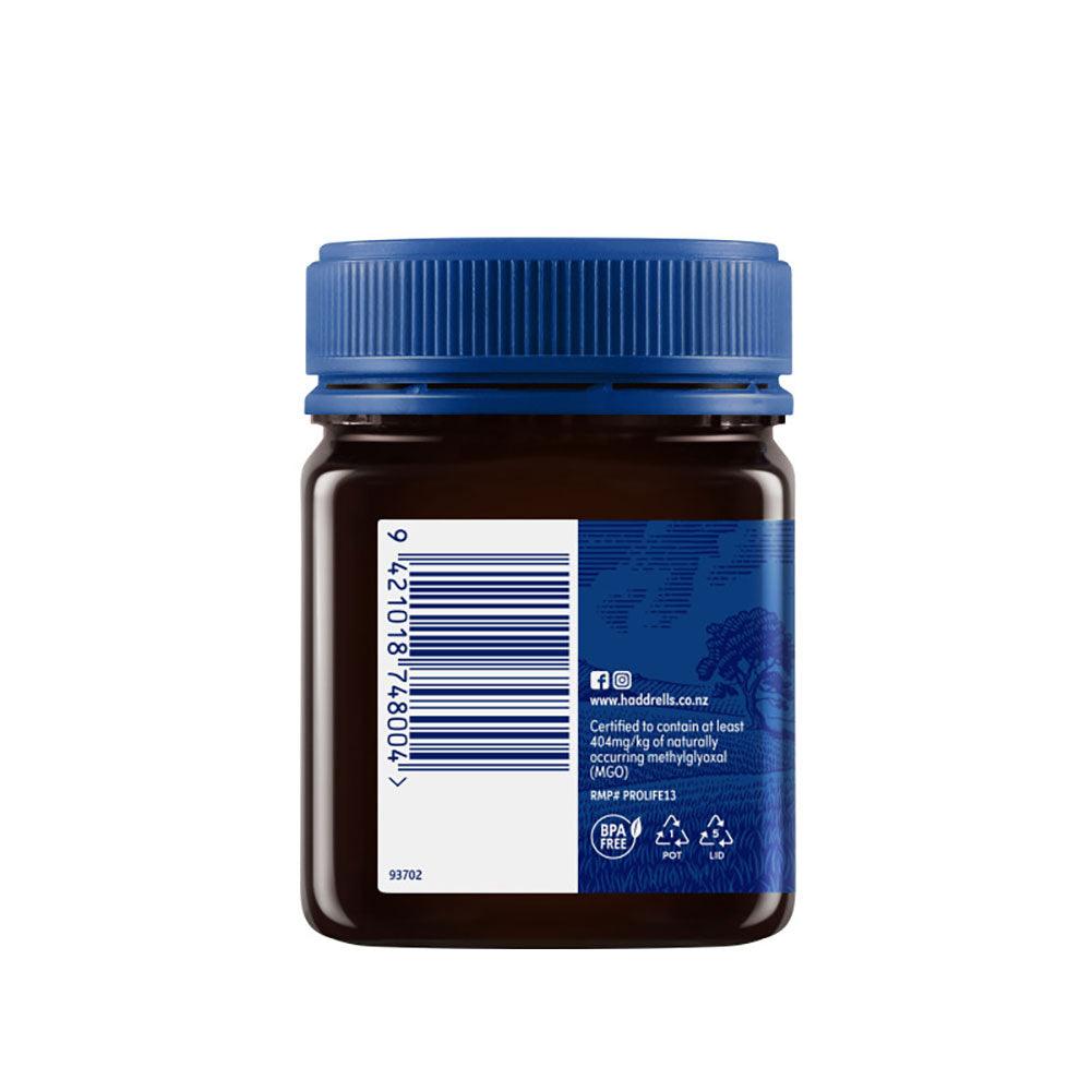 Herbalistas Haddrells Manuka Honey UMF13+ in 250g jar, showing the golden, viscous honey with a smooth texture.