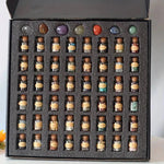 Set of 55 natural crystal gemstone bottles with various colorful stones inside, arranged in a display.