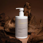 SELFNAMED Longevity Keratin Volume Boost Shampoo bottle, 390ml, with brown wood cap and label, on a neutral background.