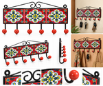 Decorative floral wall hanger with six hooks, featuring red ceramic tiles and black metal, ideal for home decor.