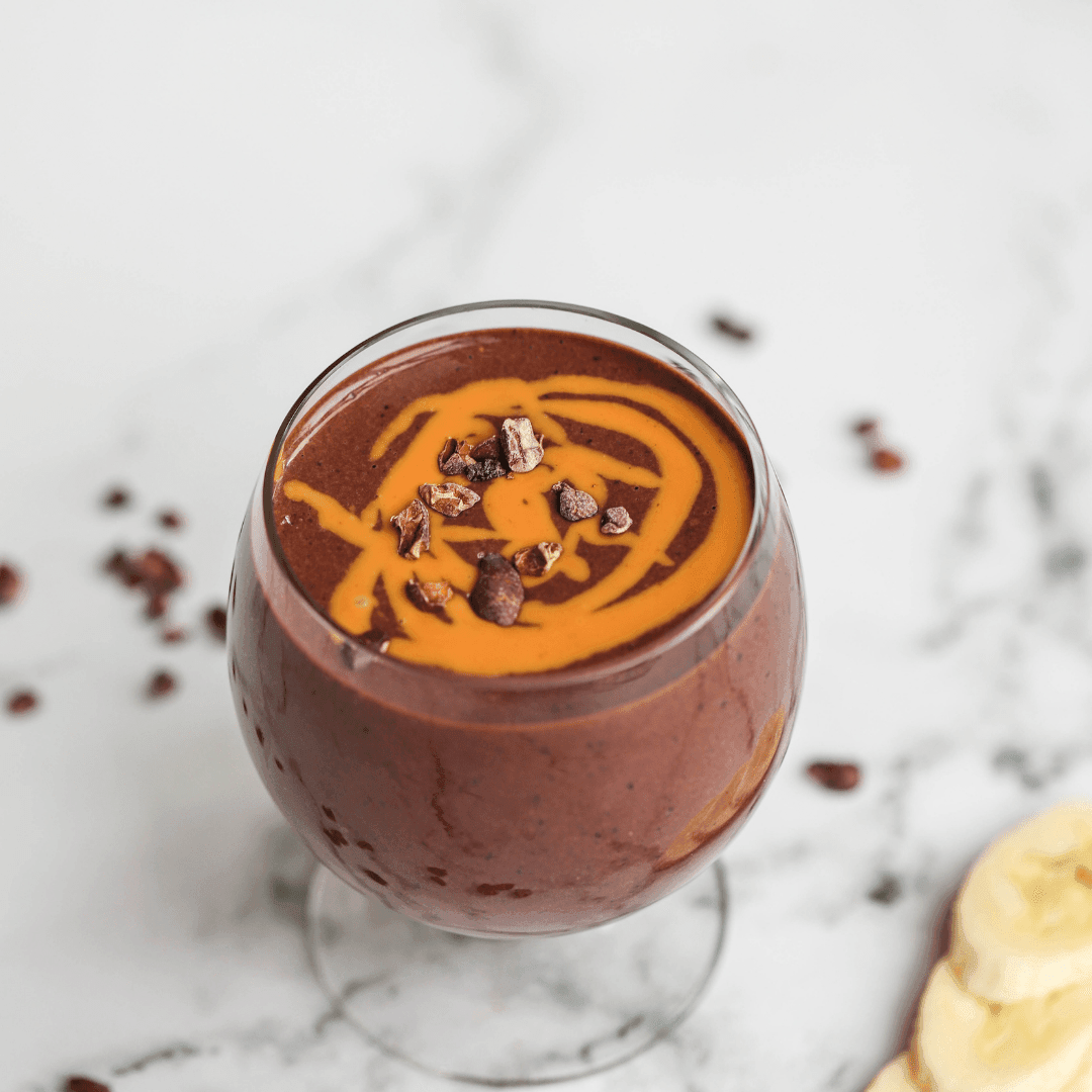 Vegan green smoothie recipe from Green Life Books, featuring a post-workout cocoa smoothie in a glass with fresh ingredients.