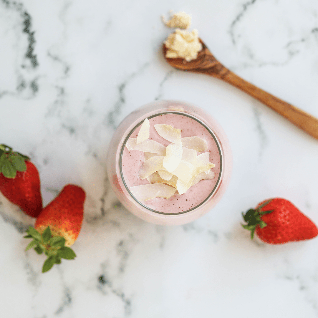 Vegan Green Life Books smoothie recipe book open to a page with a vibrant strawberry smoothie image and healthy recipe tips.