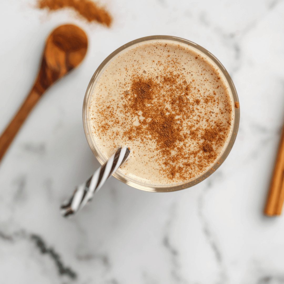 Vegan cookbook titled Green Life 30 Healthy & Delicious Smoothie Recipes showing a cinnamon roll smoothie in a glass.