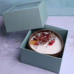 Soy wax candle in a coconut bowl by Velarte, featuring a smooth, white candle with a natural, minimalist design.