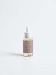 Bottle of Selfnamed Rosemary Hair & Scalp Strengthening Oil with rosemary sprigs on a white background.