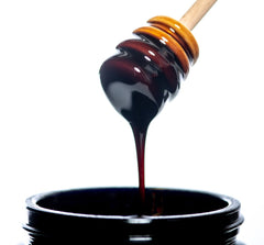 Herbalistas MountainDrop Shilajit 25g blend with raw chestnut honey in a jar, showcasing the honey's rich, textured appearance.