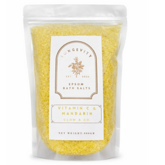Epsom bath salt with vitamin C and mandarin, featuring green and orange crystals in a clear jar, designed for relaxation and skin glow.