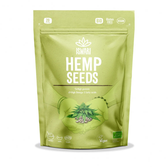 Iswari BIO hemp seeds, gluten-free superfood in 250g pack, displayed in a clear container on a wooden surface.