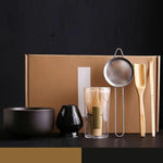 Six-piece Japanese-style bamboo matcha set with accessories, including whisk, scoop, and bowls for traditional tea preparation.