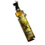 Elixir Flavours Rain Born Extra Virgin Olive Oil from Sparta, land of Sparta, with a dark glass bottle and a rustic olive grove background.
